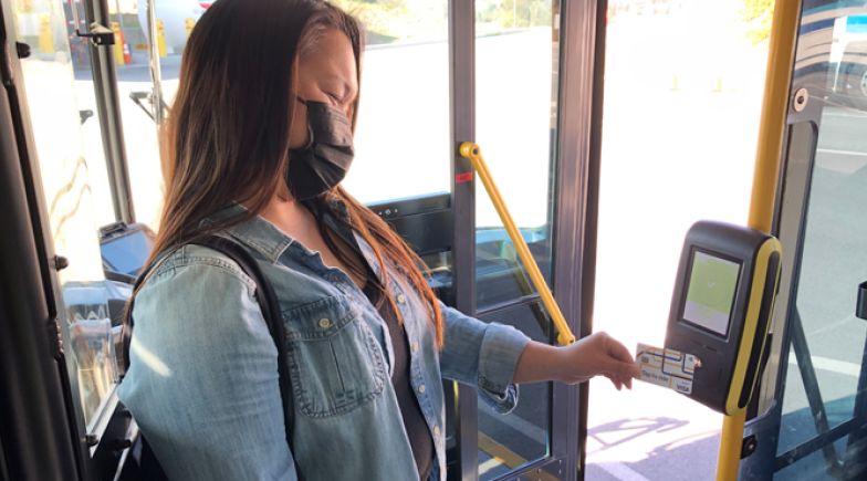 Woman using contactless to pay for the bus